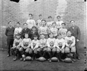 Photograph of the 1925 CAAU Junior Champion Gesu Grade School football team.