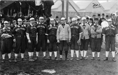 Photograph of the 1912 Kosciuszko Reds, a popular  baseball team gathered outdoors.