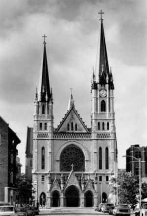 1991 photograph featuring the north facade of Gesu Church. Dedicated in 1894, its two towers are a unique feature to this landmark building.  