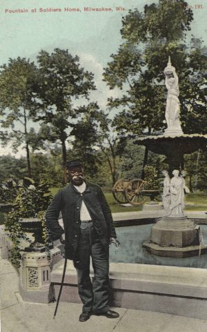 Postcard created between 1907 and 1915 featuring an African-American man by a fountain at the National Home for Disabled Volunteer Soldiers in Milwaukee. 