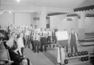 Photograph taken in 1943 of government service employees enjoying the game of bowling. 