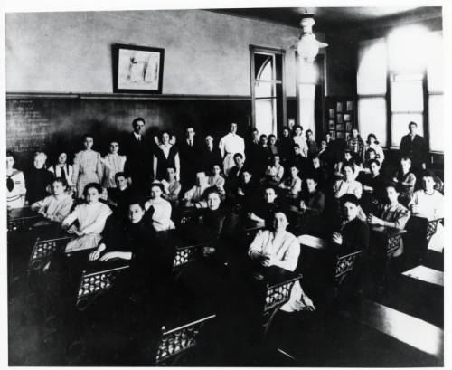 Photograph of Golda Meir and her 8th grade class taken at the 4th Street Elementary School in 1911. Meir is seen at the extreme right in a white dress. 