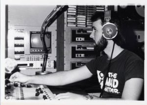 Photograph of WUWM radio engineer Bruce Winter working in the broadcast booth, taken between 1978 and 1980. 