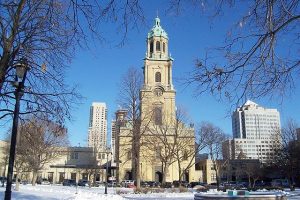 Photograph of the Cathedral of St. John the Evangelist as it is seen from across Cathedral Square Park.