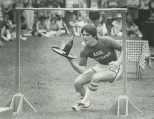 A man balances a tray with wine and wine glasses as he takes part in the Bastille Days waiters' race in 1983.