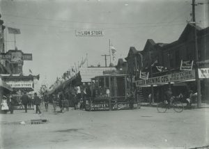 Early 20th century photograph featuring some of the shops and stands inside the Jahrmarkt, highlighting the connections between German culture and business in Milwaukee. 