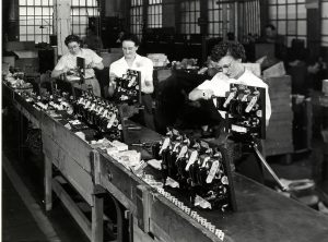 Photograph of women assembling small engines for the Allis-Chalmers Corporation. 