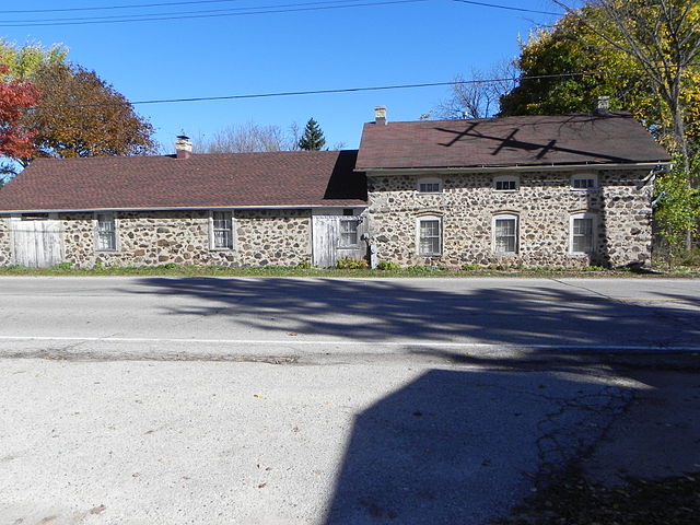 This 2014 photograph shows the nineteenth century Ritger Wagonmaking and Blacksmith Shop in its modern context.
