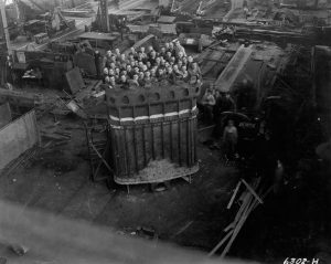 52 men stand inside a massive dipper for a 950B stripping shovel manufactured at the Bucyrus-Erie plant in South Milwaukee.