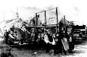 Jones Island residents stand in front of large fishing nets stretched out to dry. 