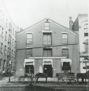 Photograph of a storefront for Layton & Co. Beef and Pork Packers on Water Street in 1888. Founded in 1863 by Frederick Layton, it was one of Milwaukee's most prominent meatpacking companies.