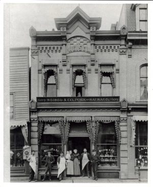 Men and women stand in front of the Weisel & Company store, founded in 1878 and located on Water Street. 