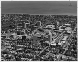 Aerial photograph of UW-M's campus taken in 1983. Lake Michigan is visible in the background and surrounding neighborhoods are in the foreground.