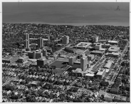 Aerial photograph of UW-M's campus taken in 1983. Lake Michigan is visible in the background and surrounding neighborhoods are in the foreground.