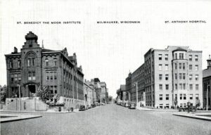 This photograph, looking north on 10th Street just south of State Street, captures three elements of the St. Benedict the Moor Mission in the 1930s: on the far right a sliver of the church (with cupola along roofpeak), St. Anthony Hospital (right of center), and the boarding school (on the left, for decades the original home of Marquette College).