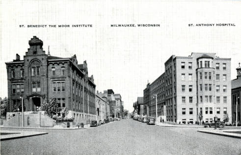 This photograph, looking north on 10th Street just south of State Street, captures three elements of the St. Benedict the Moor Mission in the 1930s: on the far right a sliver of the church (with cupola along roofpeak), St. Anthony Hospital (right of center), and the boarding school (on the left, for decades the original home of Marquette College).