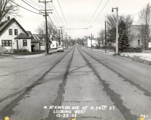 A view of Atkinson Avenue in 1953. The old streetcar rail lines have recently been paved over, but the overhead wires are still visible. 