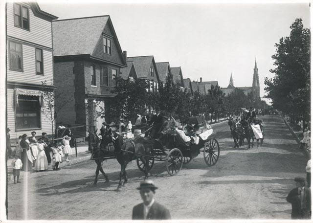 Carriages parade past Frank Burczyk Saloon on North Bremen Street in Riverwest.